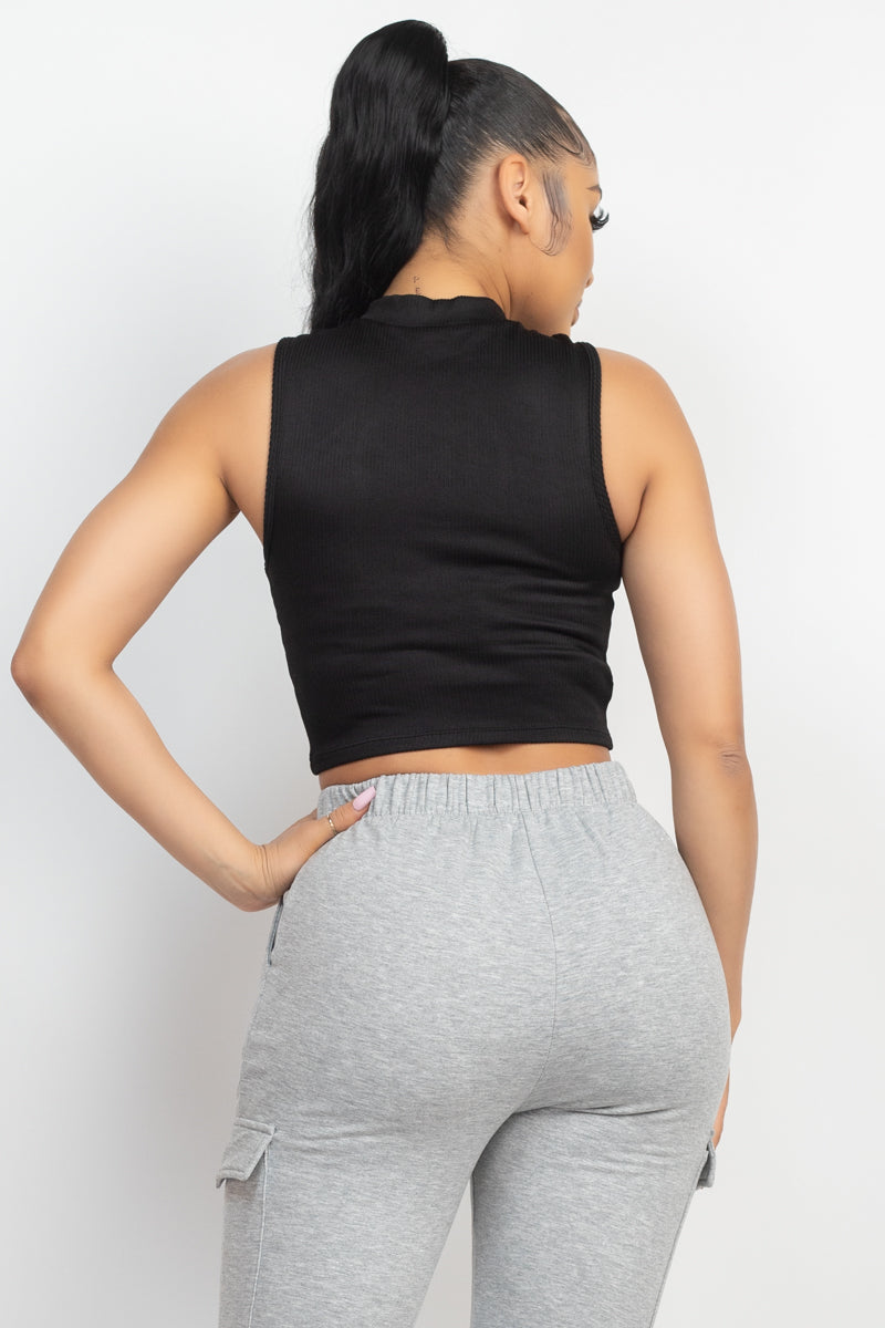 Women's black fashionable rib stretch knit crop top featuring a front keyhole, a mock neckline and a sleeveless cut back view