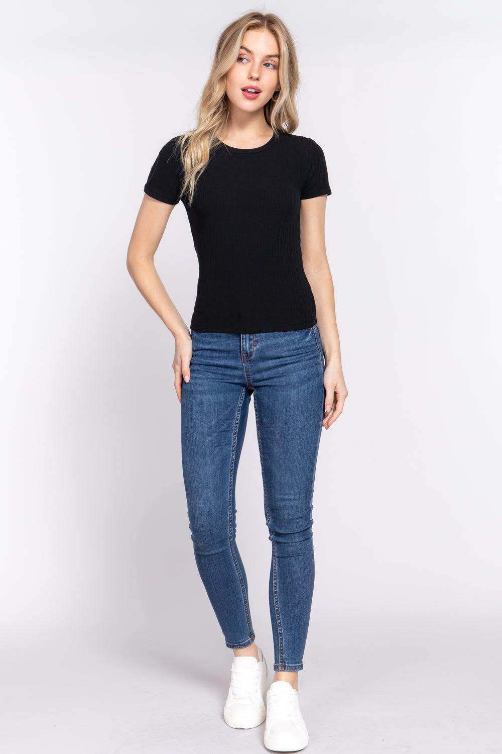 Women's black short sleeve top features a crew neckline and variegated rib knit fabric