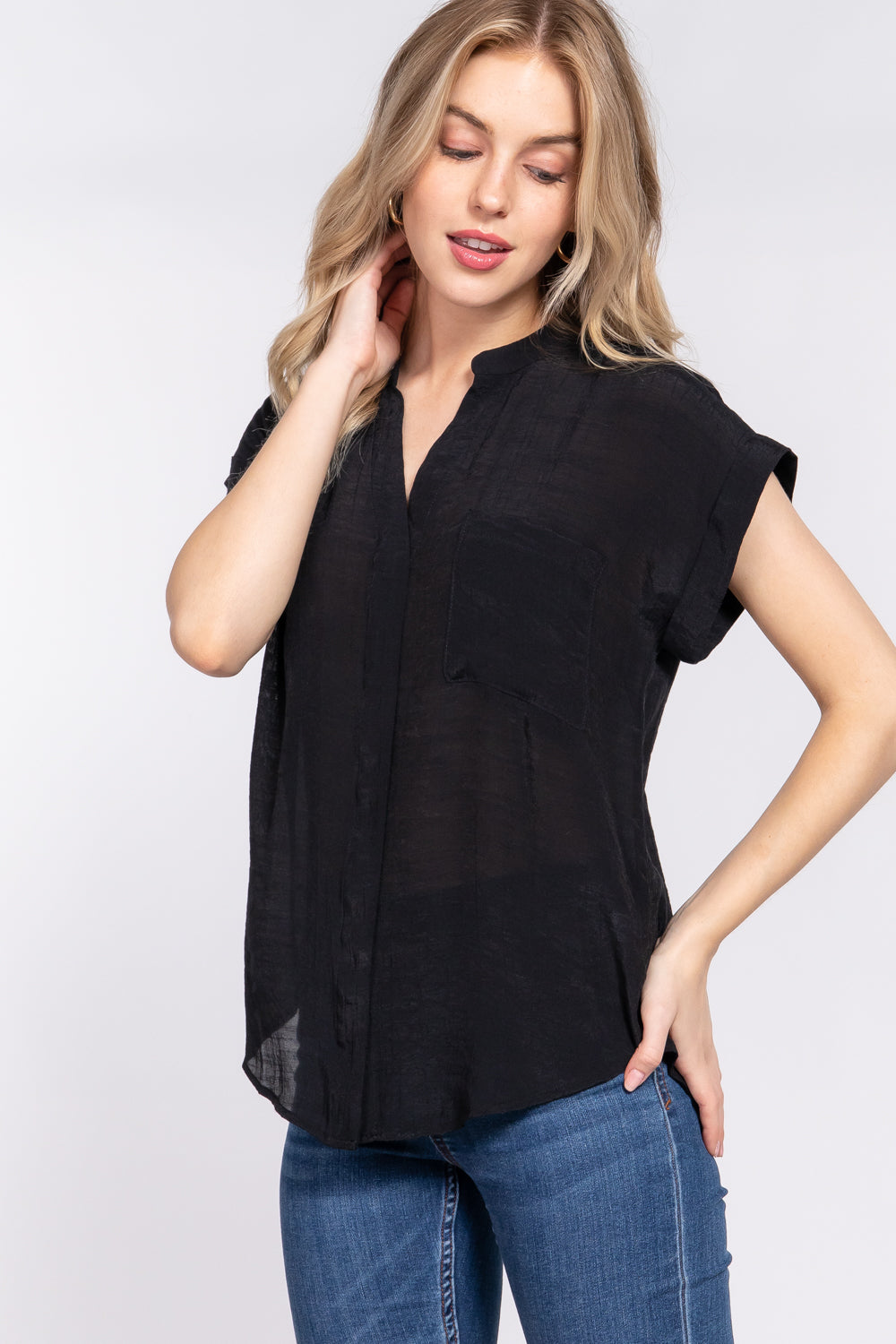 Women's black dolman sleeve woven top with open neck, front pocket, button down front and back slit.