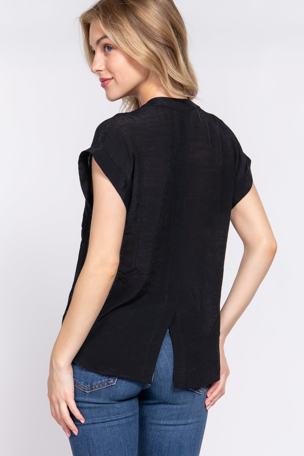 Women's black dolman sleeve woven top with open neck, front pocket, button down front and back slit. rear view